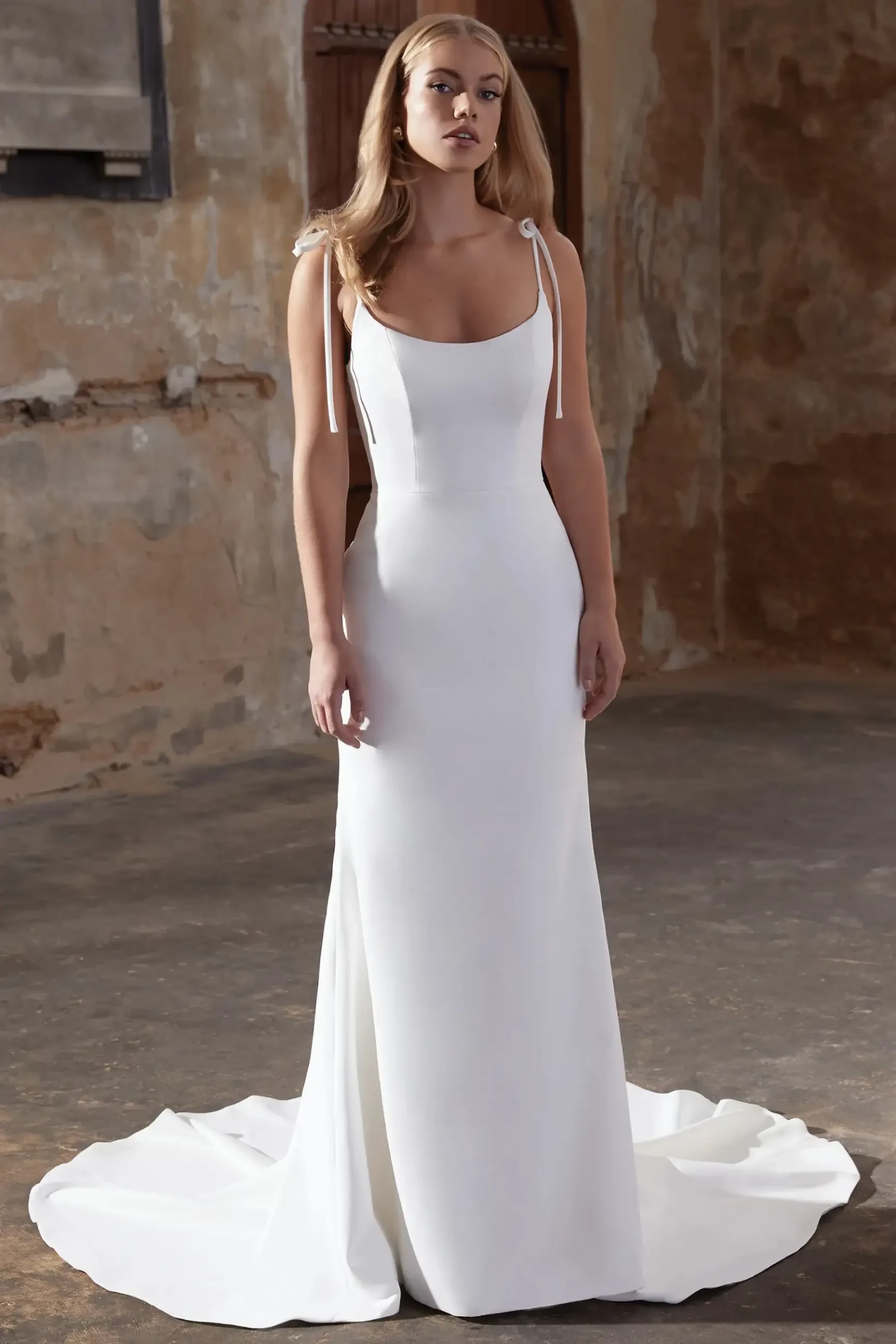 model is wearing a sleeveless fit and flare bridal gown