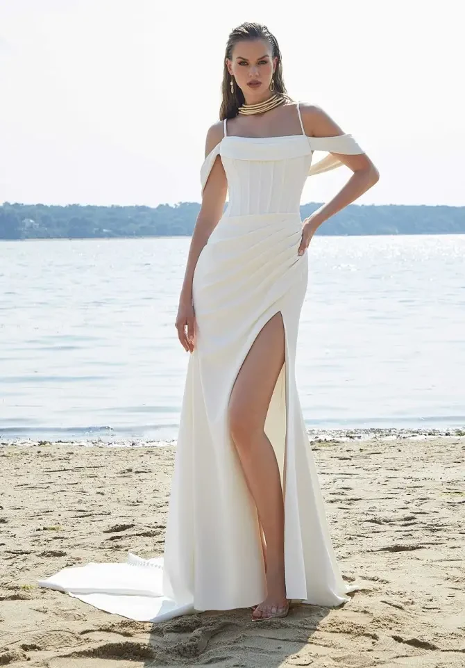 model is wearing an off the shoulder wedding gown