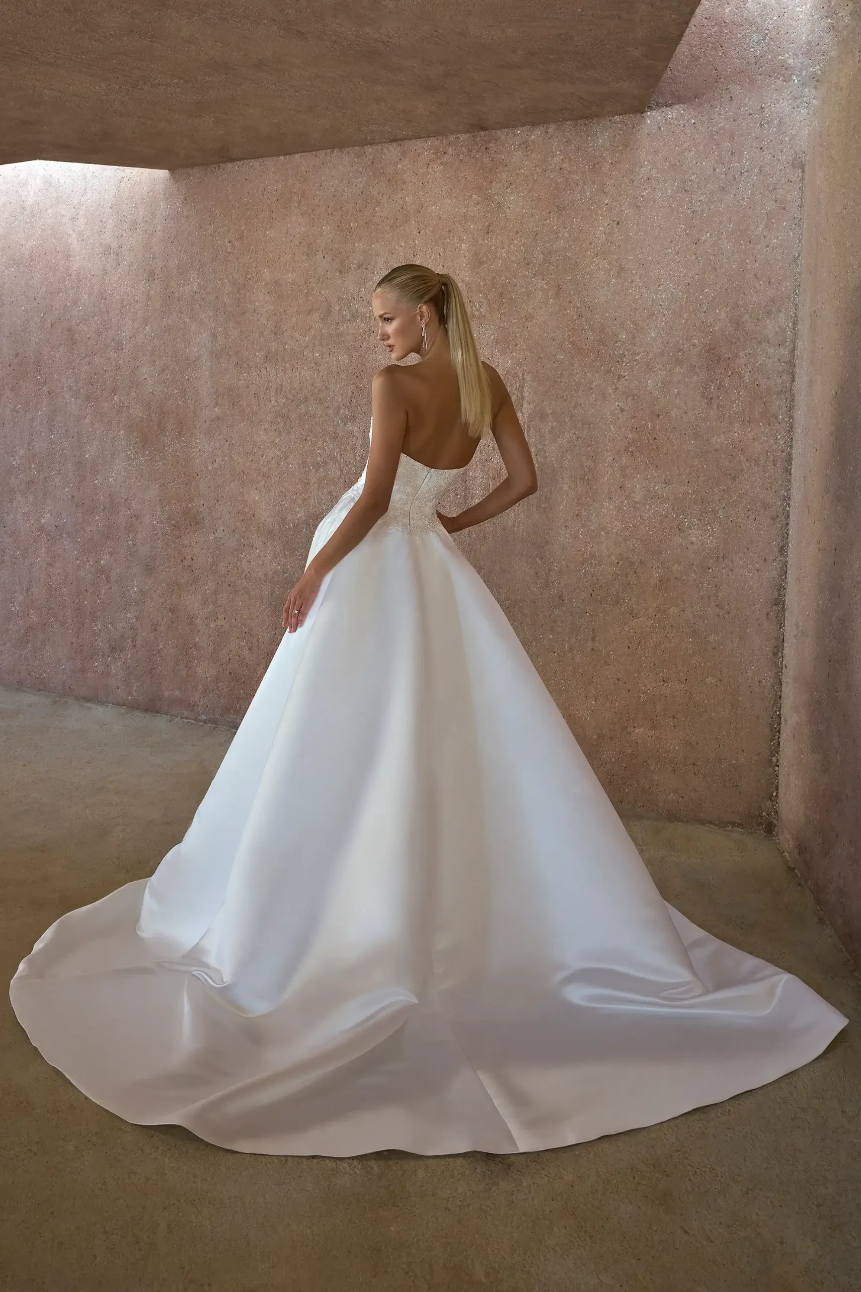 model is wearing a basque waist wedding gown