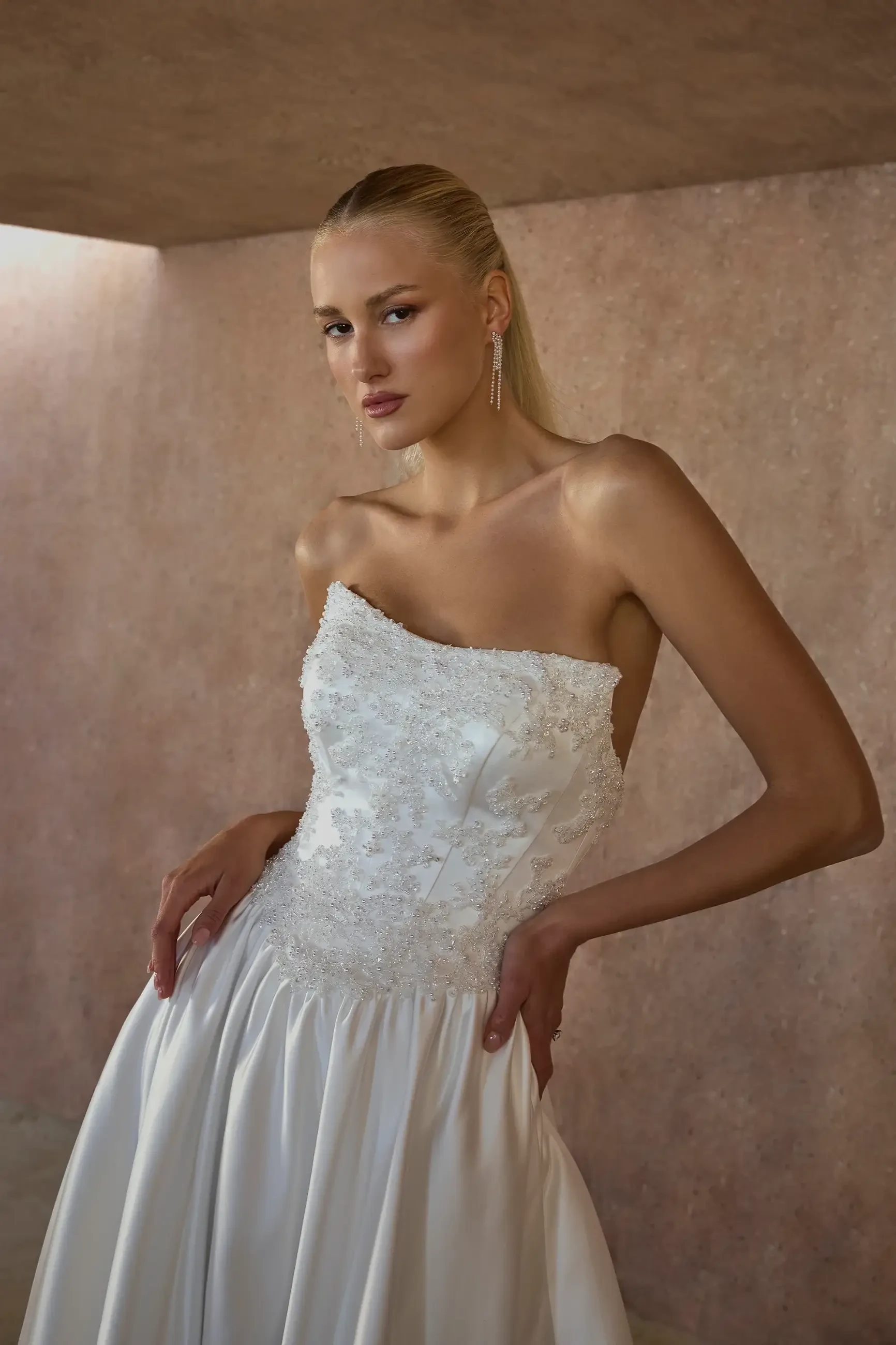 model is wearing a basque waist wedding gown