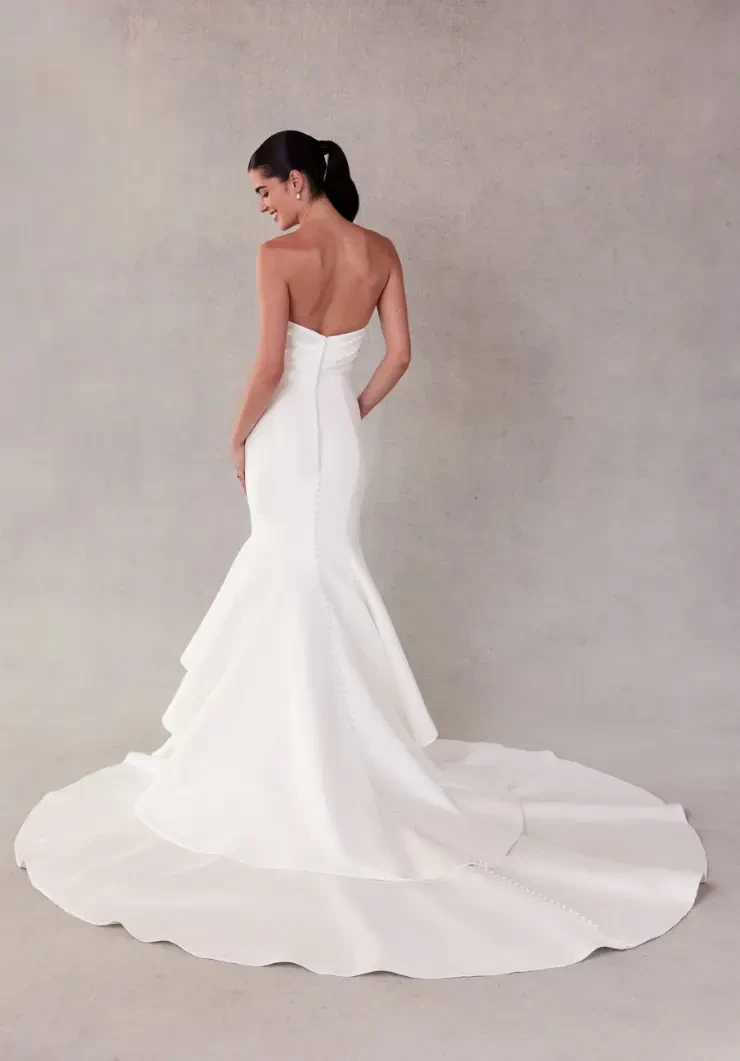 model is wearing a strapless mermaid wedding dress