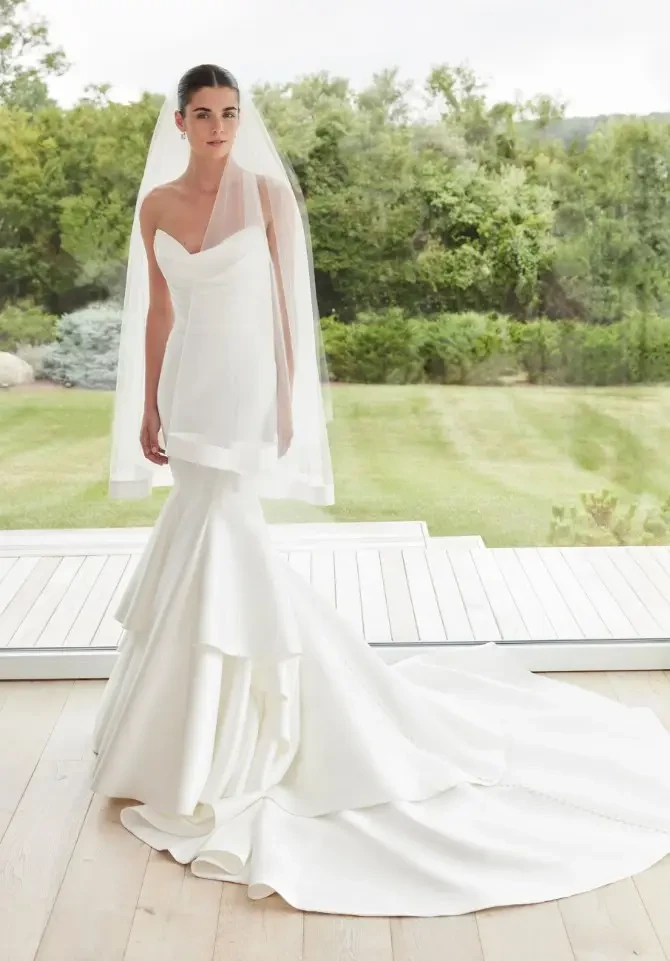 model is wearing a strapless mermaid wedding dress