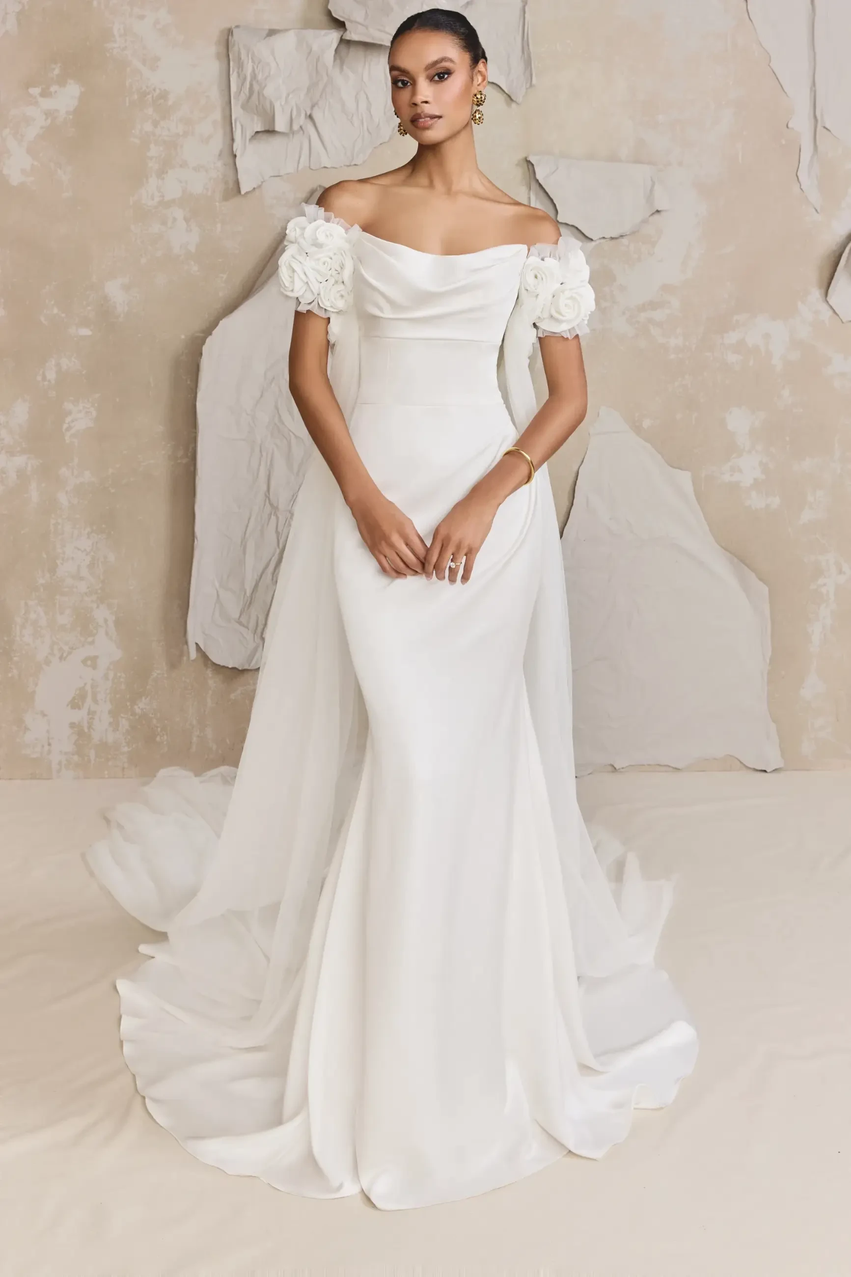 model is wearing a strapless neck wedding gown with detachable sleeves