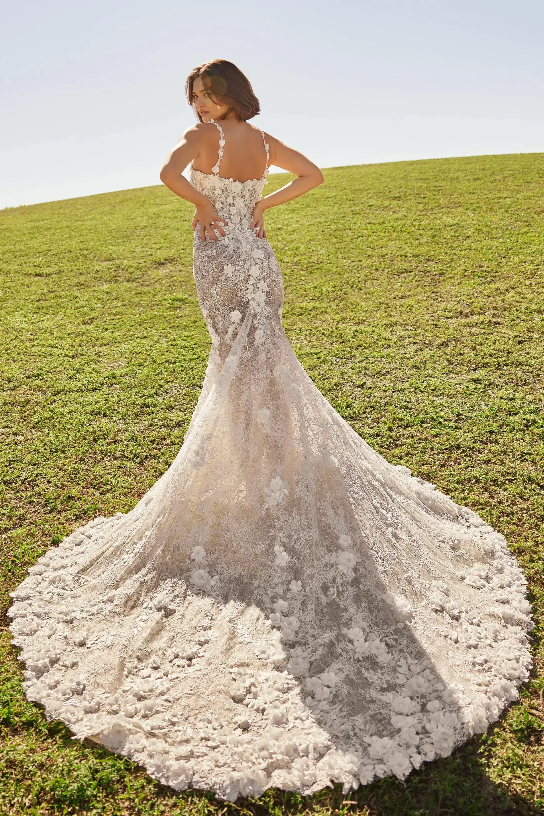 model is wearing a sleeveless fit and flare floral 3D lace bridal gown by martin thornburg