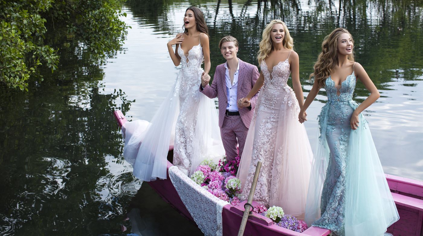 Models wearing bridal dresses near the river
